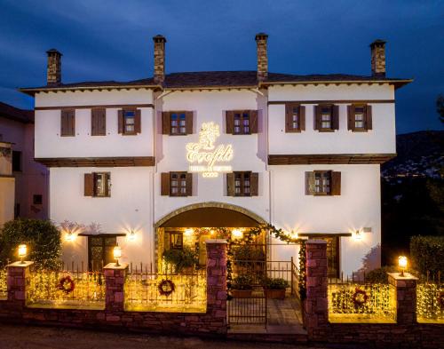 a large white building with a sign on it at Erofili Hotel & Suites in Portaria