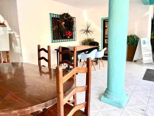 a dining room with a wooden table and chairs at Casa Puerto Morelos in Puerto Morelos