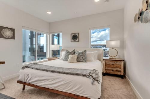 a white bedroom with a bed and a window at Newly Built Modern Park City Getaway l Zen by Stay in Park City