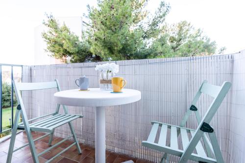 a table and two chairs on a patio at 034- Tropisme, Appart 2 chambres, Clim, Wifi, Parking in Montpellier