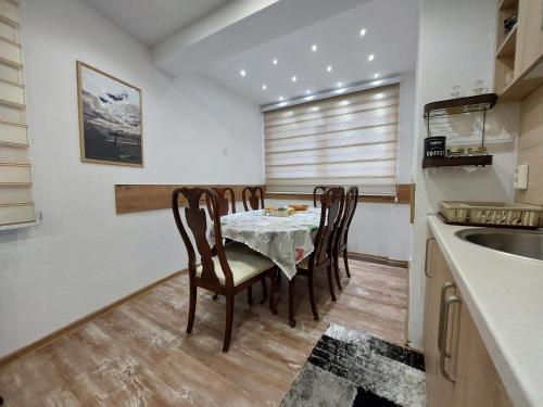 ein Esszimmer mit einem Tisch und Stühlen in einer Küche in der Unterkunft Stan SK in Pale