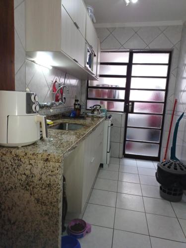 a kitchen with a sink and a counter top at Angi Hosting in Porto Alegre