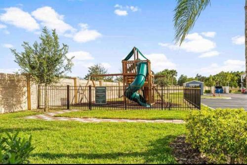 um parque infantil com escorrega num parque em Enjoy a Cozy 3 BR/Clubhouse/Near Disney and more em Kissimmee