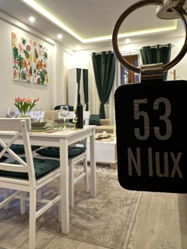 a dining room with a table and a sign that says at Milmari N lux Sena in Kopaonik