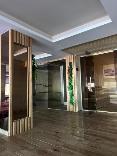 a lobby with glass doors and wood floors at Milmari N lux Sena in Kopaonik