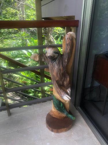 a statue of a woman leaning against a window at Sloth Premium Riverfront Jungle Villa with Jacuzzi and Pool in Uvita