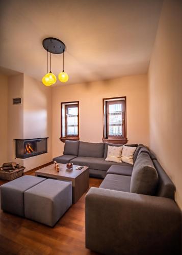 a living room with a couch and a fireplace at Erofili Hotel & Suites in Portaria