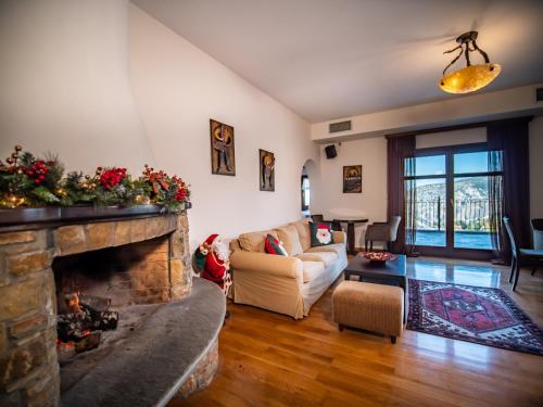 a living room with a couch and a fireplace at Erofili Hotel & Suites in Portaria