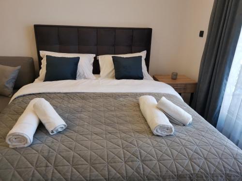a bed with two rolled up towels on it at Harmony, Residence Hill A85 in Kopaonik