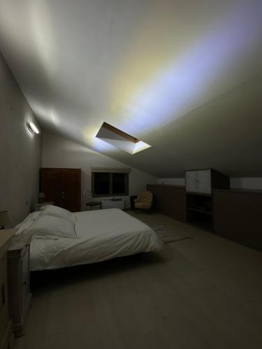 a bedroom with a large bed and a ceiling at Domaine de Nina in Houdan