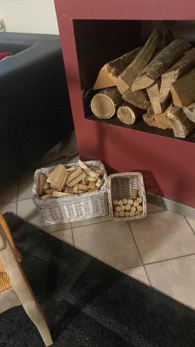 two baskets of food sitting on a floor next to a table at Domaine de Nina in Houdan