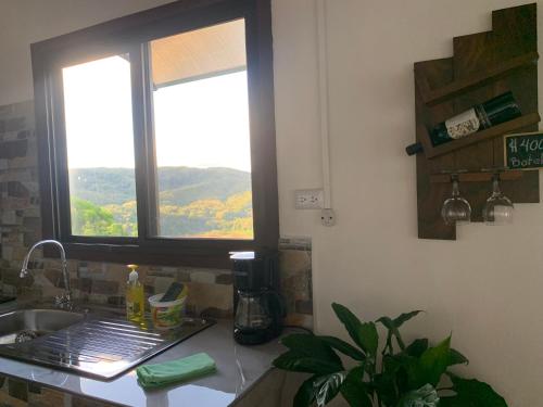 a kitchen counter with a sink and a window at Conectar con la naturaleza in Esparza