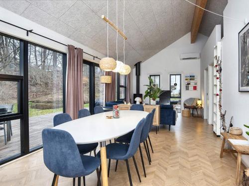 a dining room and living room with a table and chairs at Holiday home Ebeltoft CLXXXIX in Ebeltoft
