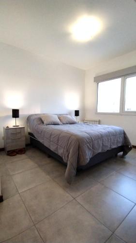 a bedroom with a large bed in a room with a window at 3 amb en zona Guemes. A pasos del Aldrey y bares. in Mar del Plata