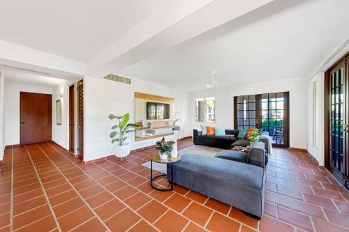 sala de estar con sofá y mesa en Villa Quenepa at Lakeside Villas, en Sabana