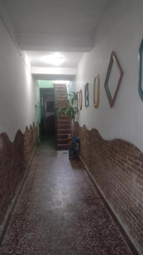 a hallway with a brick wall and a stair case at Lo de Gavy in Concepción del Uruguay