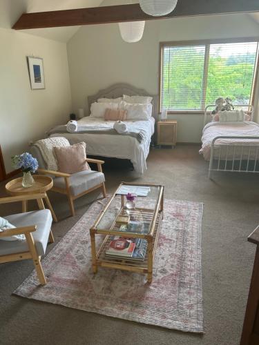 a living room with a couch and a coffee table at Summerfields B & B in Cambridge