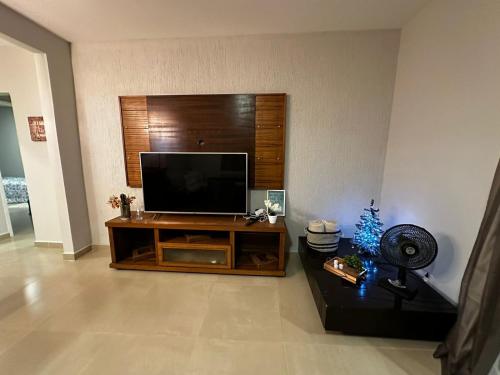 a living room with a large flat screen tv at Rancho Ameixeira in Paty do Alferes