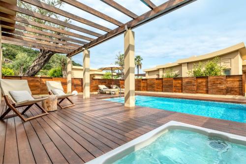 a deck with a swimming pool and a pergola at Domes Miramare, a Luxury Collection Resort, Corfu - Adults Only in Moraitika
