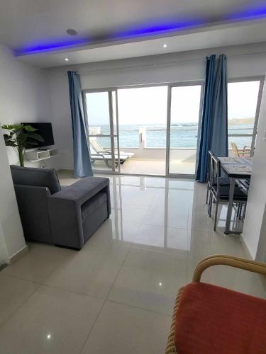 a living room with a couch and a table at Sea View Big Lanche in Praia Baixo