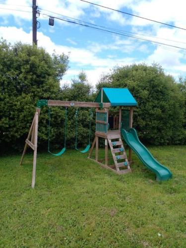 a playground with a ladder and a slide at Acogedor en parcela in Llanquihue