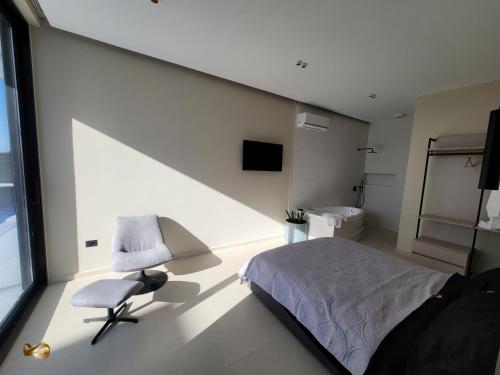 a bedroom with a bed and a chair at Infinity Villa in Rrushkull