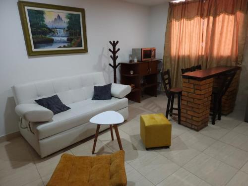 a living room with a white couch and a table at Samor centro histórico Bogota in Bogotá