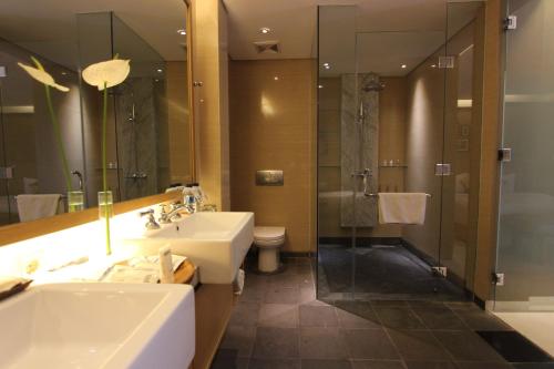 a bathroom with a sink and a shower at Ossotel Legian in Legian