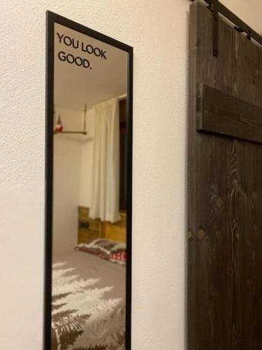 a mirror with a sign that says you look good at La Chambre de Chaloz in Valtournenche