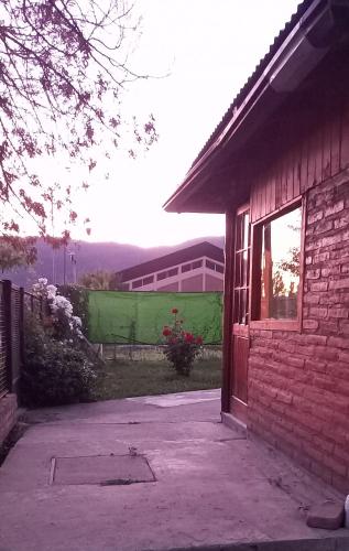 a brick building with a door and a window at Departamento Anita in El Hoyo