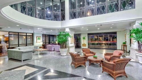a lobby of a hotel with chairs and tables at Premium Flats - Tulip Inn in Fortaleza