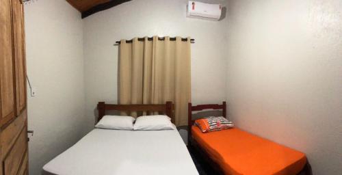 Giường trong phòng chung tại Casadabiquinha
