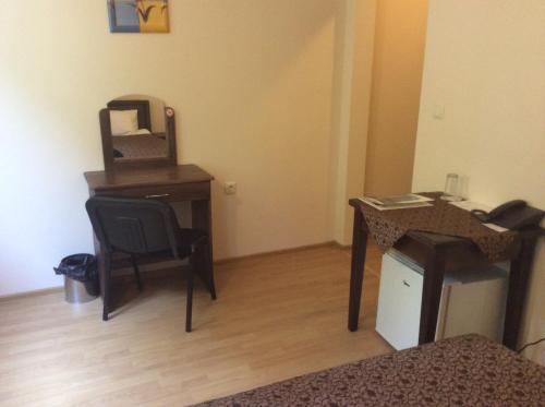 a room with a desk and a chair and a desk with a computer at Hotel Terazini in Veliko Tŭrnovo