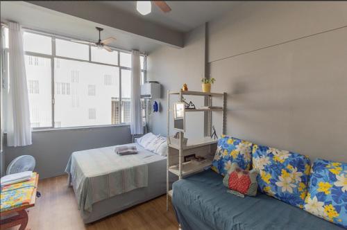 a living room with a couch and a bed at Studio no Largo da Carioca - Rio de Janeiro in Rio de Janeiro