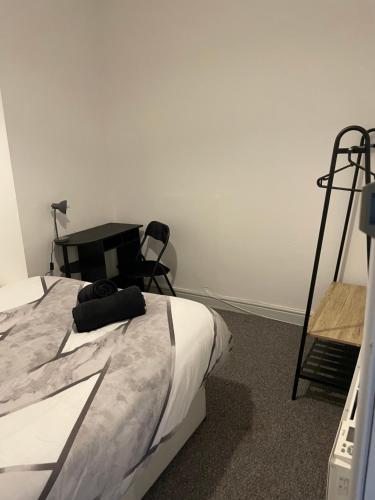 1 dormitorio con cama, escritorio y silla en Tiye cosy stays en Stoke on Trent