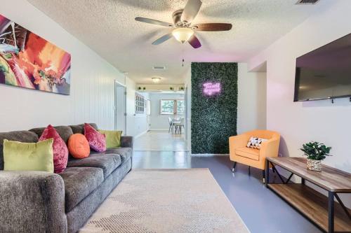 a living room with a couch and a ceiling fan at Spacious Tampa Haven - Games - Pool - 7-15 min From ALL in Tampa