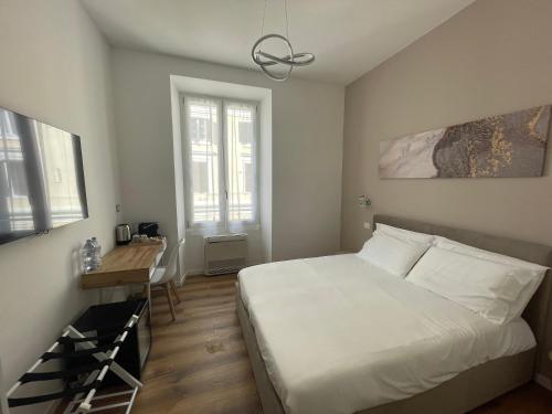 a bedroom with a bed and a desk in it at Belltower Elegans Guest House in Rome