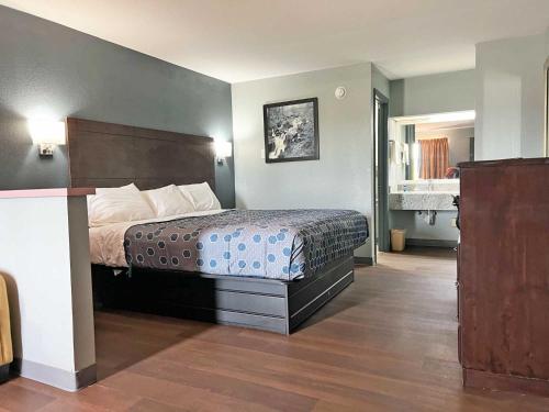 a hotel room with a bed in a room at Red Carpet Inn & Suites in Newnan