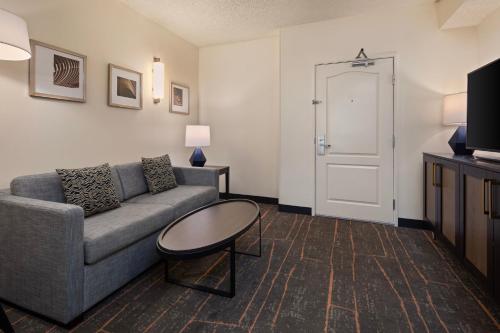 a living room with a couch and a table at Holiday Inn Hotel & Suites Maple Grove Northwest Minneapolis-Arbor Lakes by IHG in Maple Grove