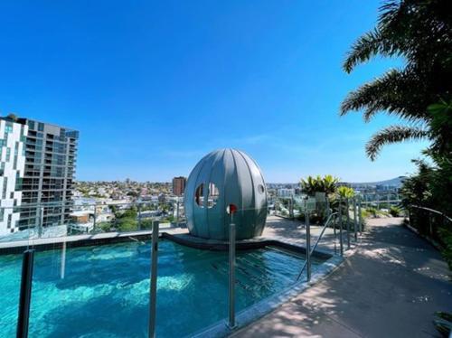 a pool with a dome on top of a building at Light apartment in amazing central location in Brisbane