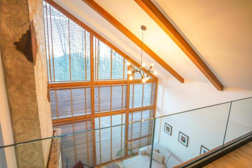 an attic staircase with a large window at Holiday Villas in Orllan