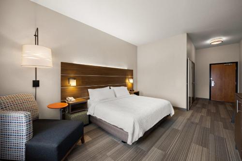 a hotel room with a bed and a chair at Holiday Inn Express Hotel & Suites Limon I-70/Exit 359 by IHG in Limon