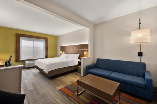 a hotel room with a bed and a couch at Holiday Inn Express Hotel & Suites Limon I-70/Exit 359 by IHG in Limon