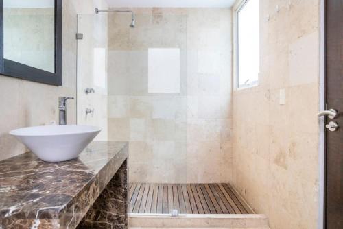 a bathroom with a sink and a shower at Condesa Residence Amsterdam 303 Exquisite 1 Bedroom, 1 Bathroom Residence on Amsterdam Avenue in Mexico City
