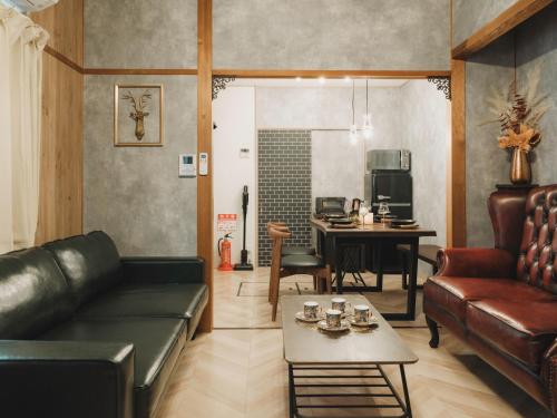 a living room with a couch and a table at 駅徒歩1分 静かな阿倍野の一棟貸し 長期滞在向け 最大6名 Tsubame INN Abeno in Osaka