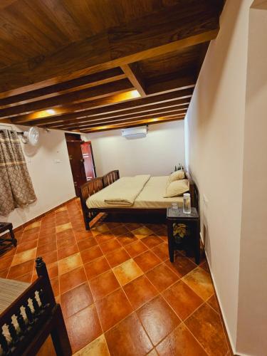 a small room with a bed and a table at Moksha The blissful escape in Kaniyāmbetta