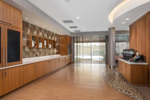 a large hallway with wooden cabinets and a television at SpringHill Suites by Marriott Downtown Chattanooga/Cameron Harbor in Chattanooga