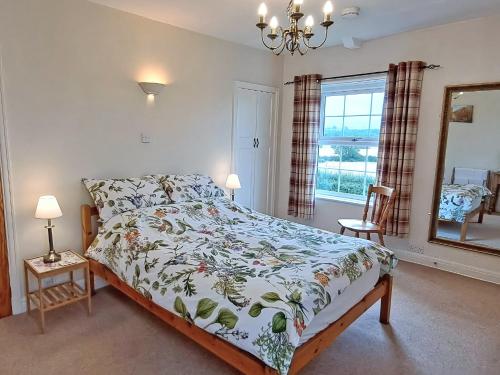 a bedroom with a bed and a mirror at Foston Grange Cottage in Bulmer