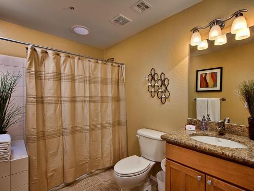 a bathroom with a toilet and a sink and a shower at Scottsdale Vacation Rentals in Scottsdale