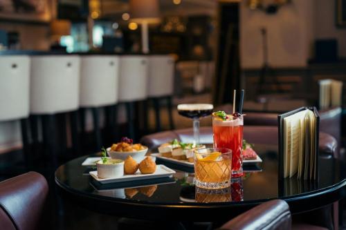 a table with two plates of food and drinks on it at Hamburg Marriott Hotel in Hamburg